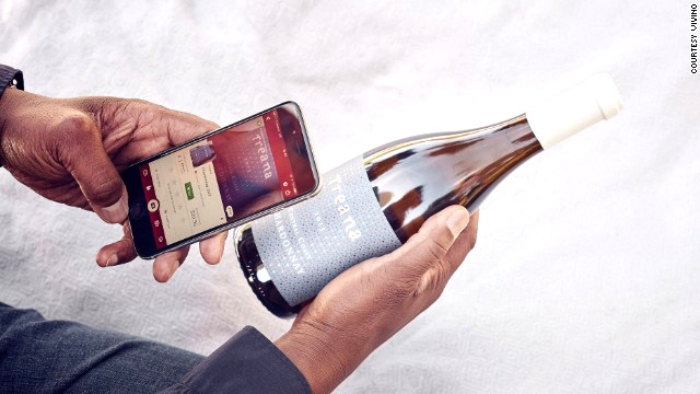 Man taking a picture of wine bottle