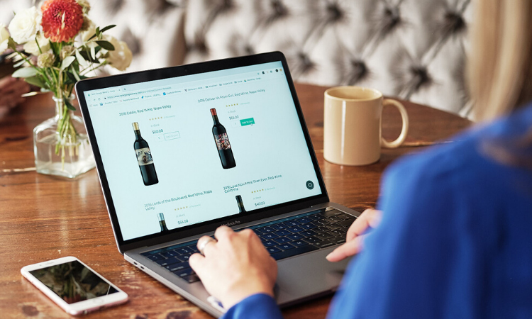 Shopping for wine online using laptop